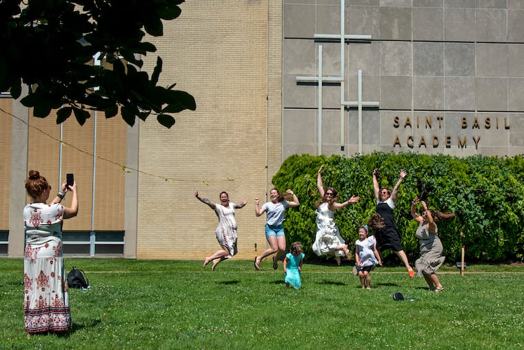 Jillian Fornito, Class of '00, takes a photo of her sisters and classmates as they join other alumna taking a final chance to walk through St. Basil Academy. Jumping for her are Emily Loeffer (Pale), '07 (from left) Abby Pale, '14; Kathleen Dayhoff (Pale), '03; Danielle Drigo, '03; and Molly Fornito, '03. The children are Kathleen's daughter, Quinn, 4; and Danielle's, Violet, 6.