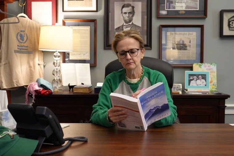 U.S. Rep. Madeleine Dean reading the viral book "Inner Excellence" at her desk in preparation for the Super Bowl.