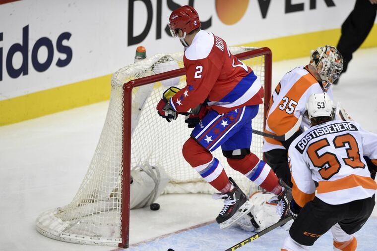 Washington Capitals defenseman Matt Niskanen (2) scores a goal past Philadelphia Flyers goalie Steve Mason (35) during the third period of an NHL hockey game, Sunday, Feb. 7, 2016, in Washington. Flyers defenseman Shayne Gostisbehere (53) looks on.