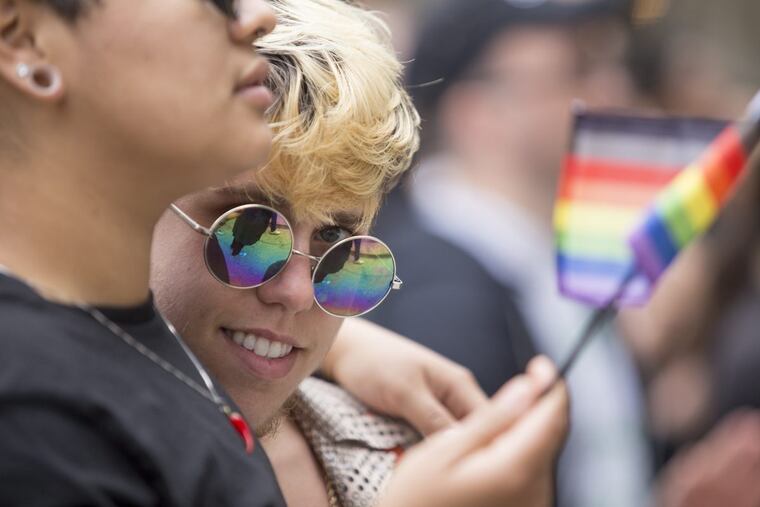 Jamie Joy (right) celebrates with Cilantro Flores at the 2017 Pride Month kick off at City Hall.
