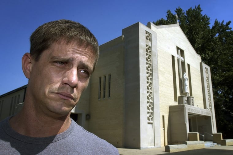 John Delaney, standing in front of St. Cecilia Church in Northeast Philadelphia, says he was repeatedly abused by the Rev. James Brzyski as a child.