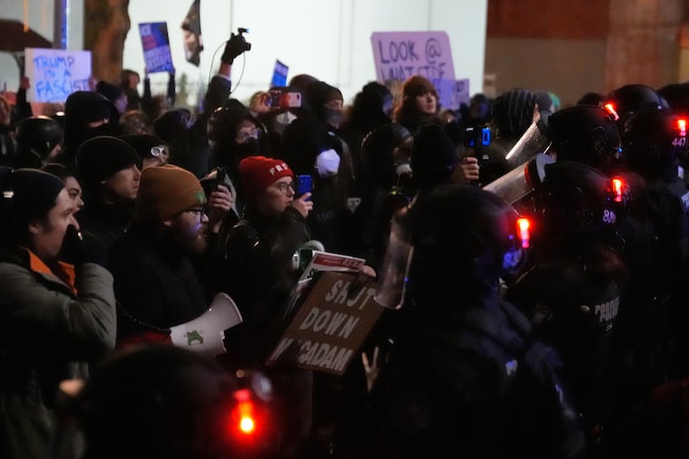 Protesters stand off against law enforcement outside the U.S. Immigration and Customs Enforcement facility in Portland, Ore., on Thursday, Jan. 8.
