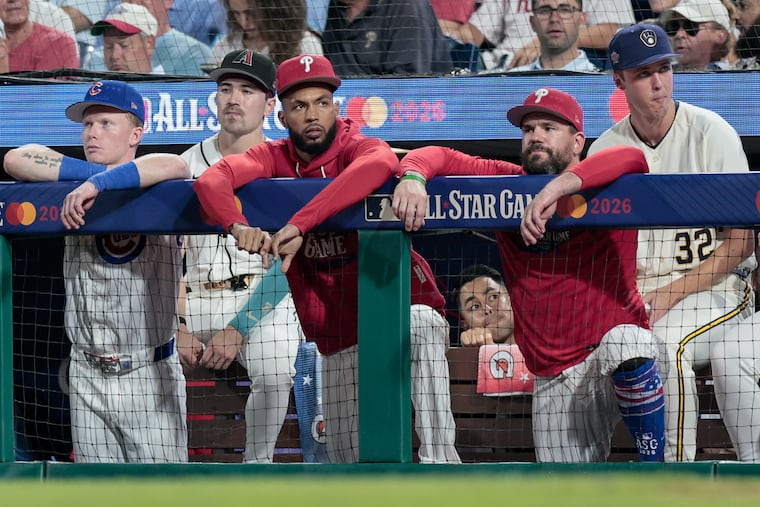 Cristopher Sanchez and Kyle Schwarber watch from the National League dugout during the All-Star Game Tuesday.