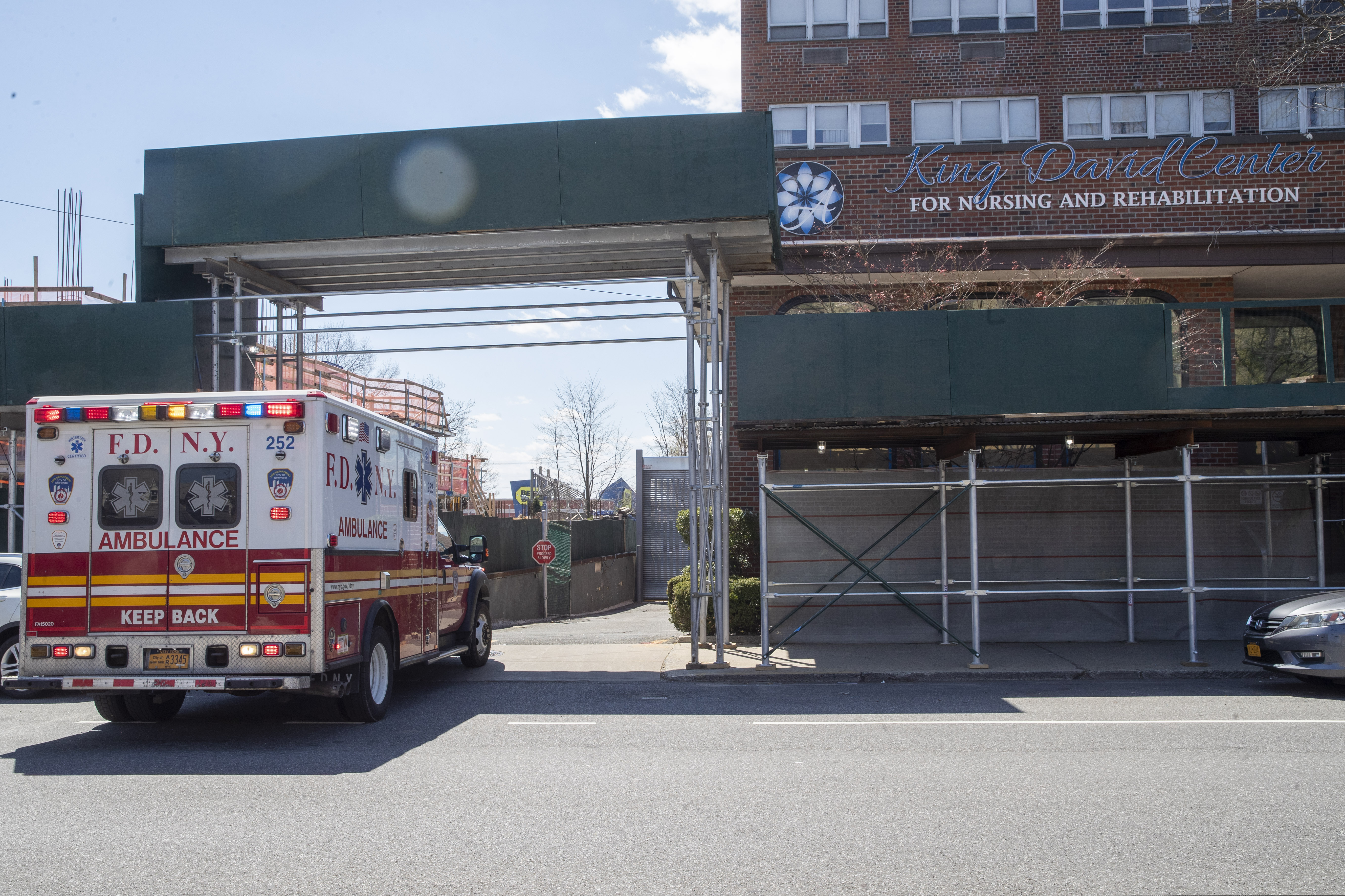 An ambulance backs out of the King David Center for Nursing and Rehabilitation in the Brooklyn borough of New York.