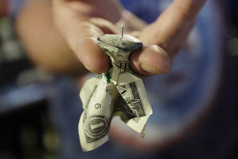 Westside Saloon owner/bartender Billy Scott shows a finished "kiss" for the "buck chuck" at the saloon in West Wildwood, NJ.
