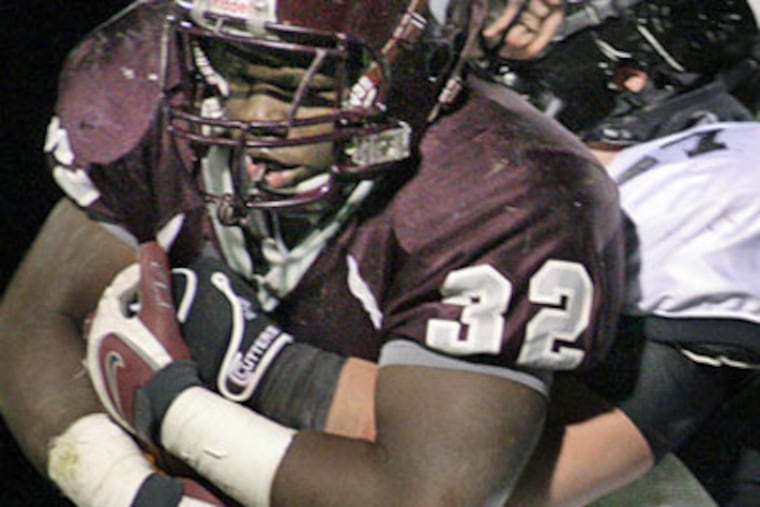 Bishop Eustace's Ed Mitchell (right) has Holy Cross ballcarrier Aaron Fant in his grasp. Holy Cross moved to the state title game against tonight's St. Joseph-Hudson Catholic winner. (Elizabeth Roberts / Staff Photographer)