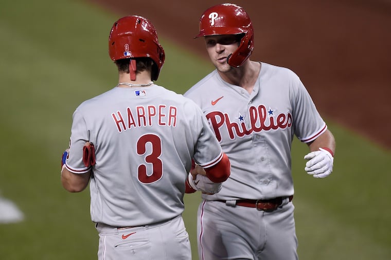 Phillies first baseman Rhys Hoskins celebrates with Bryce Harper after hitting a two-run home run in the fifth inning of Wednesday night's 9-5 victory over the Washington Nationals.