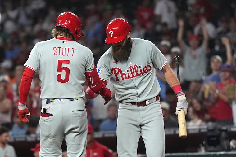 Philadelphia Phillies' Bryson Stott (5) celebrates his home run against the Arizona Diamondbacks with Phillies' Brandon Marsh during the second inning of a baseball game, Monday, Aug. 31, 2026, in Phoenix. (AP Photo/Ross D. Franklin)