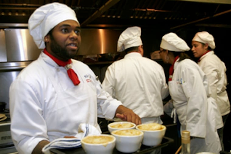 Lennie Payne, a student at JNA Institute of Culinary Arts in Philadelphia, holds French onion soup he helped make. The institute's restaurant serves lunch and dinner Tuesdays through Fridays.