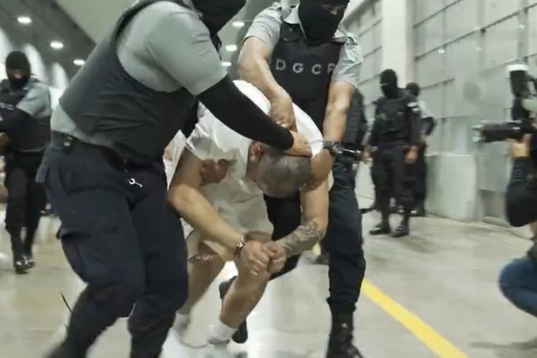 In this undated photo provided by the U.S. District Court for the District of Maryland, a man identified by Jennifer Vasquez Sura as her husband, Kilmar Abrego Garcia, is led by force by guards through the Terrorism Confinement Center in Tecoluca, El Salvador.
