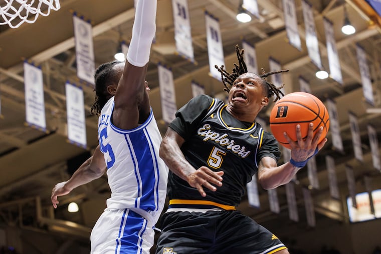 La Salle's Khalil Brantley (5) lays it in over Duke's Mark Mitchell during their game on Nov. 21. Brantley, who chose to remain an Explorer after initially planning to transfer, has keyed La Salle's 8-2 start.