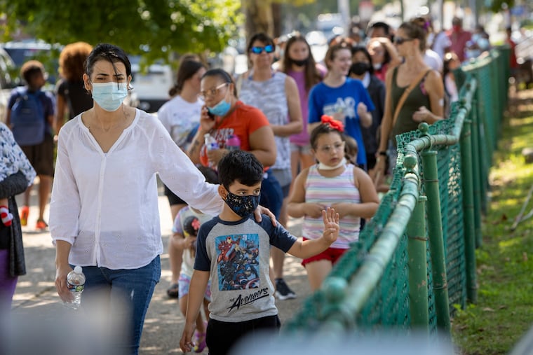 Families wait in line to collect school supplies being given out at the Jardel Recreation Center earlier this month.