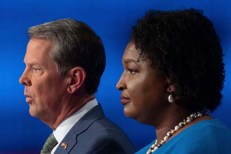 Georgia's Republican Gov. Brian Kemp (left) and Democratic challenger Stacey Abrams face off in a televised debate in Atlanta on Oct. 30.