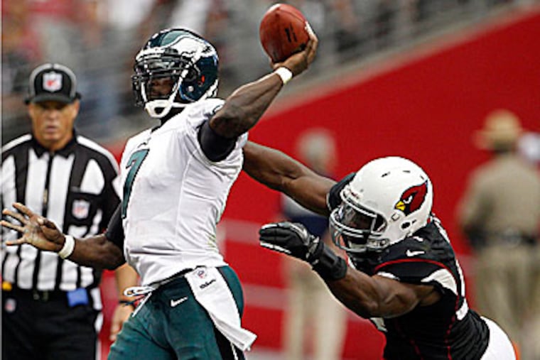 Eagles quarterback Michael Vick was sacked five times in the loss to Arizona. (Yong Kim/Staff Photographer)