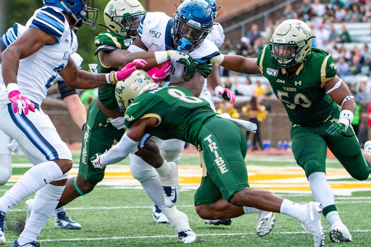 The William and Mary defense swarms Villanova running back Justin Covington.