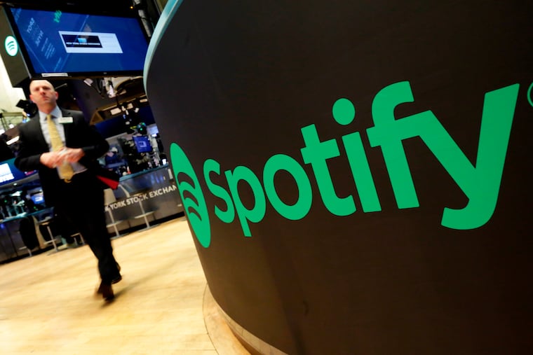 A trading post sports the Spotify logo on the floor of the New York Stock Exchange in 2018.