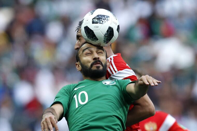 Saudi Arabia's Mohammed Alsahlawi, foreground, jumps for the ball with Russia's Alexander Samedov during the group A match between Russia and Saudi Arabia which opens the 2018 soccer World Cup at the Luzhniki stadium in Moscow, Russia, Thursday, June 14, 2018.