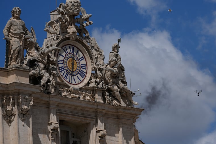 Black smoke billows from the chimney of the Sistine Chapel where 133 cardinals are gathering to elect a successor to late Pope Francis.