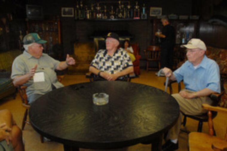 Longtime members (from left) Carmine Cancelliere, Bob Hardcastle and Jim Bagnell gather inside the clubhouse. The association is soliciting political support to keep its lease.