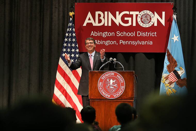 U.S. Secretary of Defense Ashton Carter acknowledges a standing ovation from the students at Abington Senior High School in Abington, Pa. on Mar. 30, 2015. Carter graduated from the high school in 1972. ( DAVID MAIALETTI / Staff Photographer )