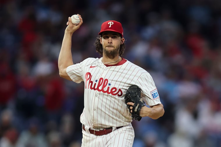 Phillies starter Aaron Nola throws to first base during the win over the Cubs that clinched the National League East title.