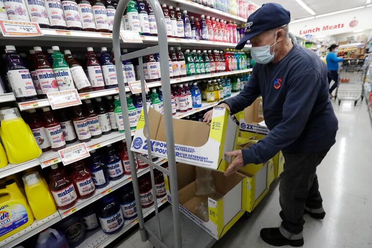 Juan Santos stocks shelves at the Presidente Supermarket in the Little Havana neighborhood of Miami.