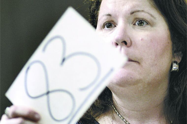 Mary Burdsall, single mother of three, bids during Col. Kirk S. Williams' Famous Grocery Auction. (Michael S. Wirtz / Staff)