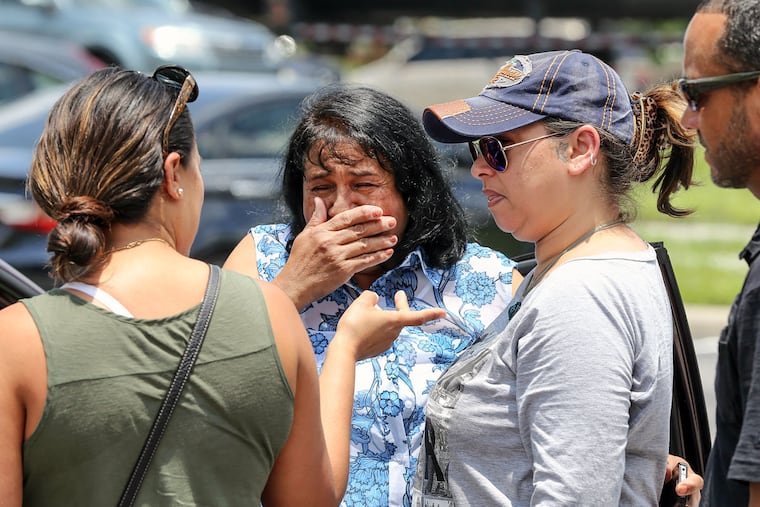 Family members of Luis Daniel Conde visit the memorial at the salon in Kissimmee where Pulse nightclub massacre victims Conde and his coworker Juan Rivera Velasquez worked.