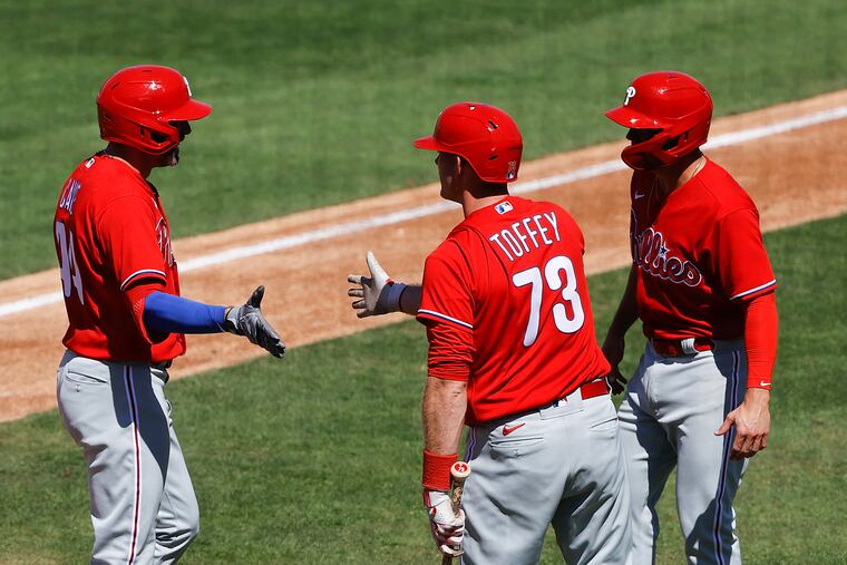 The Phillies' Jake Cave (left) celebrates his two-run home run in the second inning with teammates Will Toffey (center) and Scott Kingery on Wednesday.