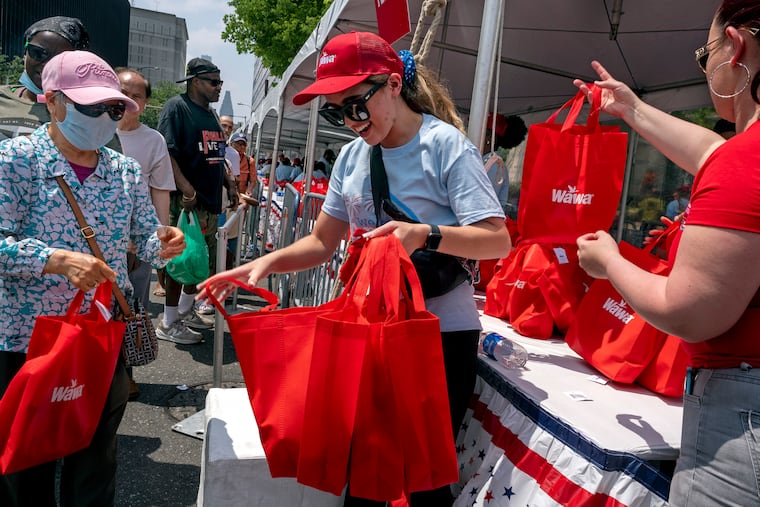 Wawa employees Hayleigh Wentz and Aliza Hughes (right) keep the hoagie goodie bags and the line moving. Wawa stores in the region also built and donated more than 30,000 hoagies to local first responders and community heroes serving their neighborhoods.