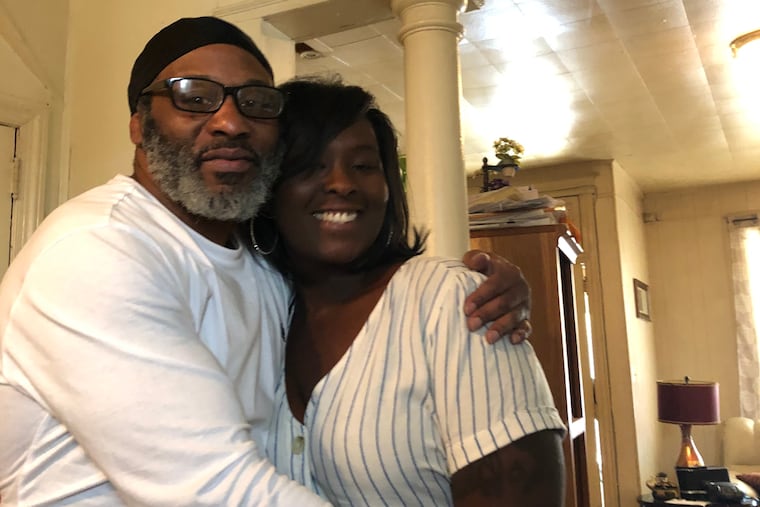 Mark Whitaker hugs Tienne Whitaker, his niece.