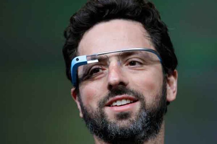 FILE - This June 27, 2012 file photo shows Google co-founder Sergey Brin demonstrating Google's new Glass, wearable internet glasses, at the Google I/O conference in San Francisco. Google is starting to notify 8,000 people who will be invited to buy a test version of the company’s much-anticipated Internet-connected glasses for $1,500. The invitations are being sent to the winners of a contest conducted a month ago. Google asked U.S. residents to submit applications through Twitter or its Plus service to explain in 50 words or less how they would use a technology that is being hailed as the next breakthrough in mobile computing. (AP Photo/Paul Sakuma, file)