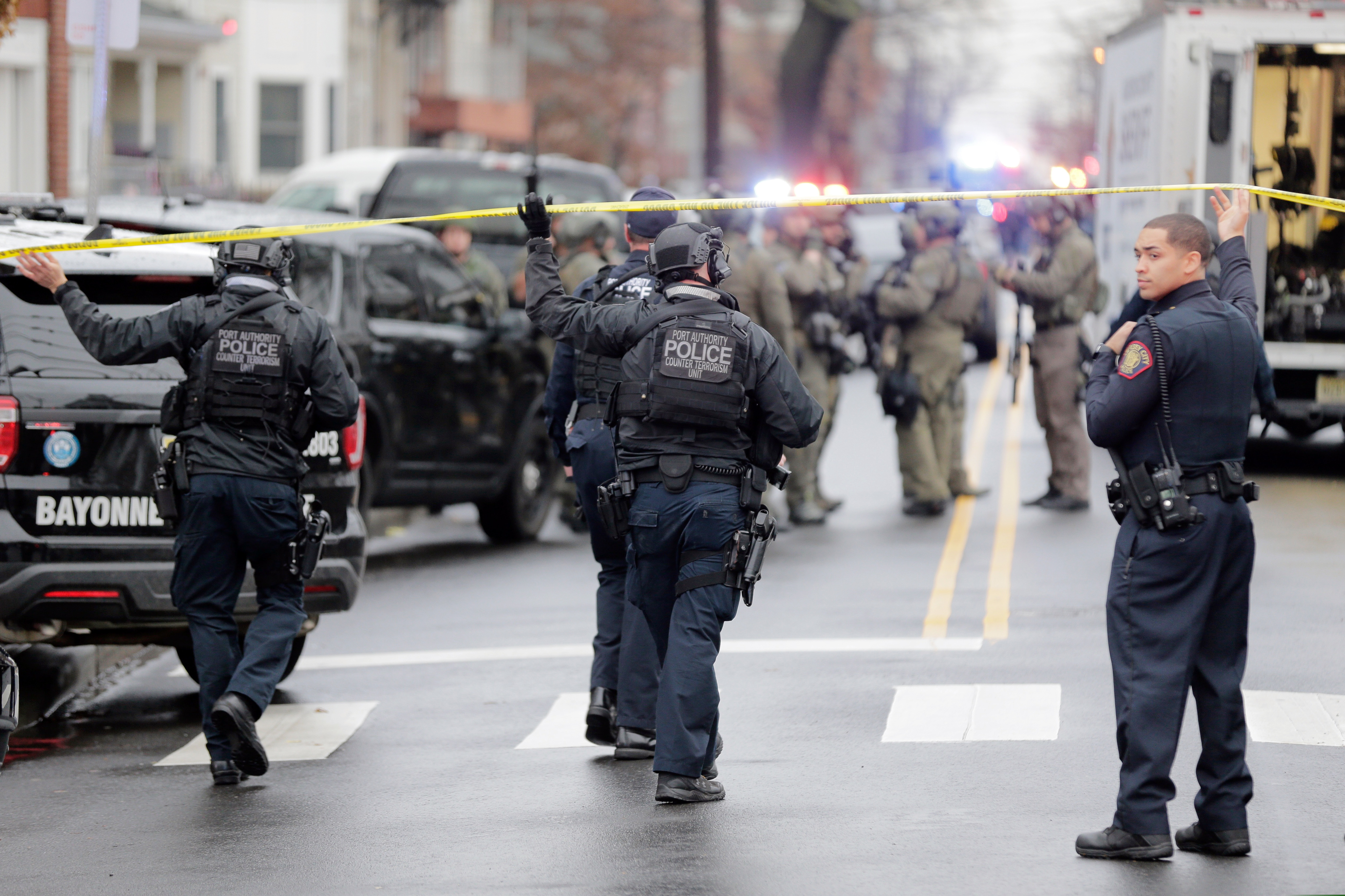 Port Authority Police officers arrive at the scene following reports of gunfire in Jersey City, N.J.