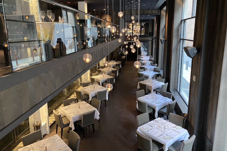 Tables along the Bach Place windows at Steak 48 at 260 S. Broad St.