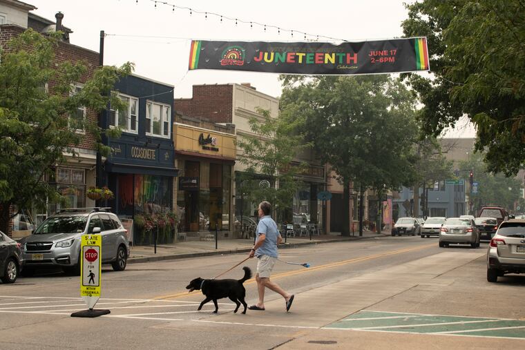 A lone pedestrian crosses Haddon Avenue near Collings Avenue in Collingswood. A landmark restaurant closed in May, but locals say recent store openings attest to downtown's continuing vitality.