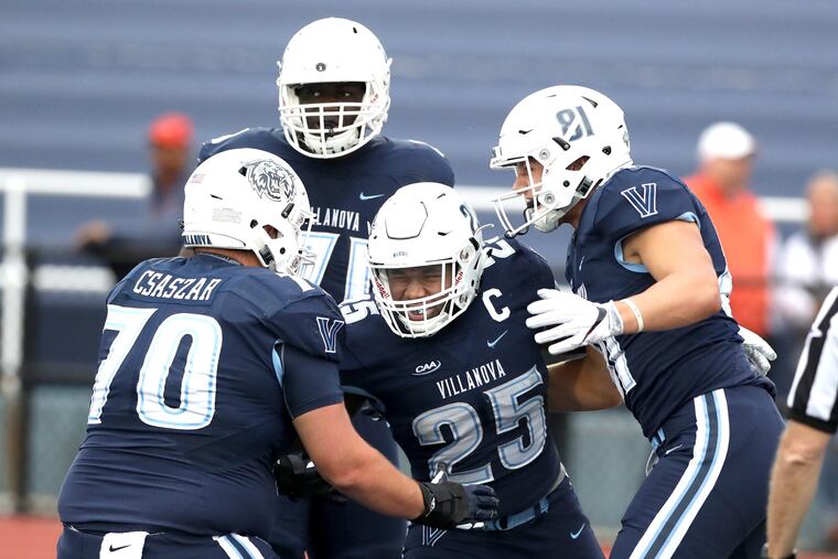 Aaron Forbes, center of Villanova celebrates with teammates including Louie Csaszar, left, and Simon Bingelis after scoring a touchdown against Bucknell in the 1st quarter at Villanova Stadium on Sept. 22, 2018. CHARLES FOX / Staff Photographer