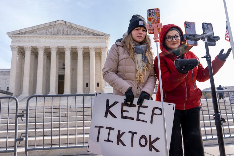 Sarah Baus (left) of Charleston, S.C., and Tiffany Cianci, who says she is a "long-form educational content creator," livestream to TikTok outside the Supreme Court on Jan. 10.