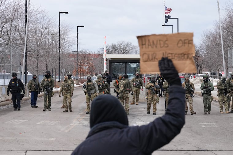 Protesters confront federal immigration officers outside the Bishop Henry Whipple Federal Building in Minneapolis this week.