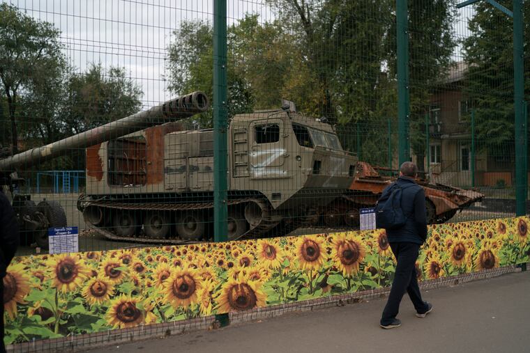 A man walks past a display of destroyed Russian military vehicles during the Defender of Ukraine Day in Kryvyi Rih, Ukraine, on Friday.