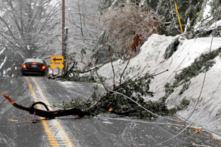Downed trees and power lines have Red Lion Road closed between Pine Road and Philmont Avenue in Lower Moreland Township, Montgomery County. (Tom Gralish / Staff Photographer)