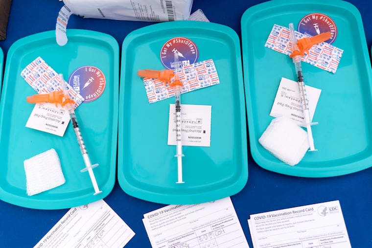 In this May 19 photo, Pfizer COVID-19 vaccine doses are prepared for members of the community 12 years and up, at a clinic held by Community of Hope, outside the Washington School for Girls in southeast Washington.