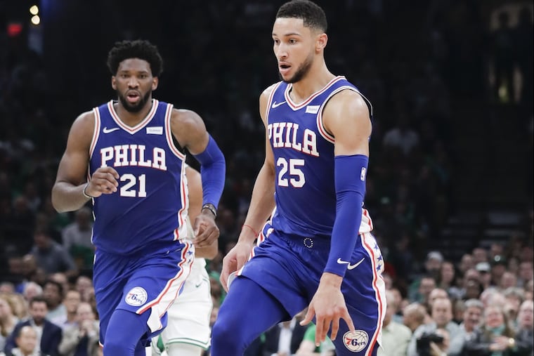 Sixers guard Ben Simmons dribbles the basketball on a fast break with center Joel Embiid against the Boston Celtics on Tuesday, October 16, 2018 in Boston.