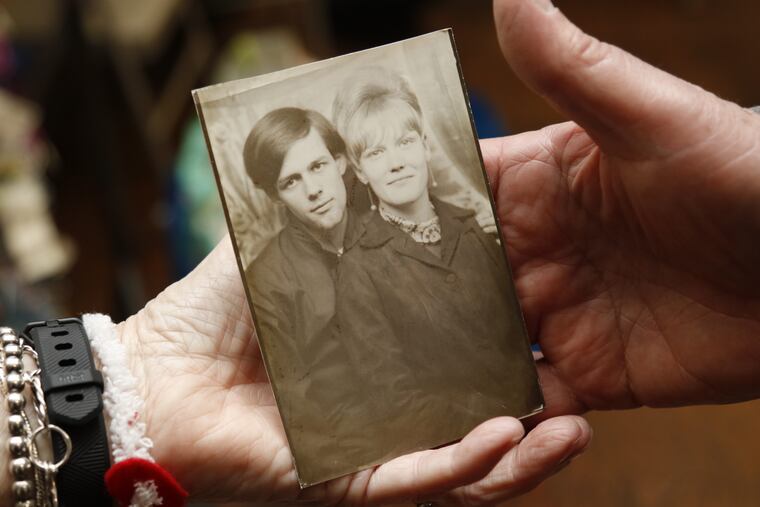 Bea and David Kelley hold a portrait of themselves that was taken in 1966, three years before they married.