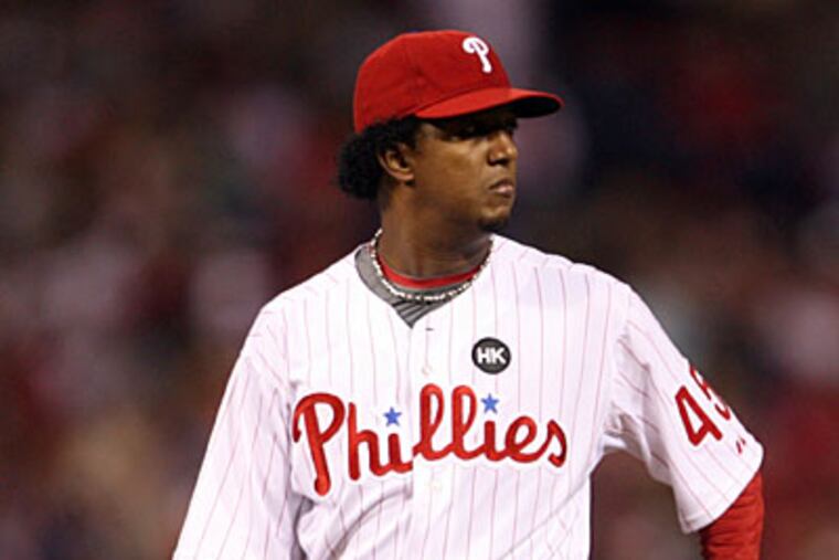 Phillies' pitcher Pedro Martinez looks over at first base after Houston Astros' J.R. Towles hit a second inning solo-home run. ( Yong Kim / Staff Photographer )