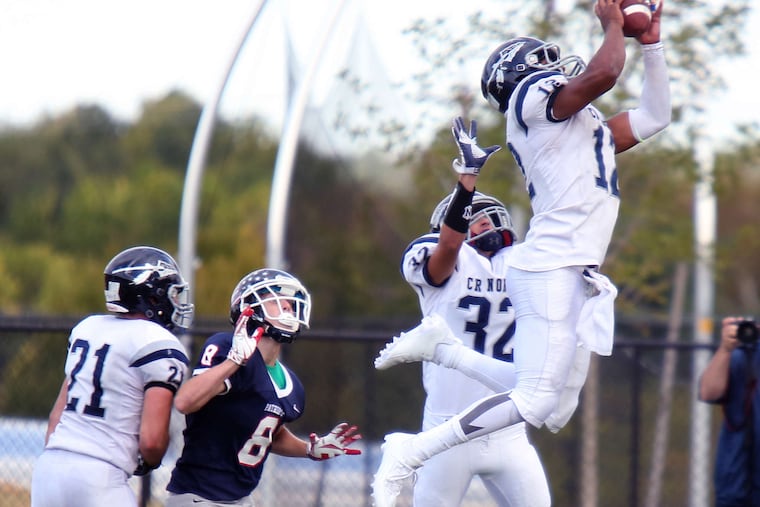 Council Rock North's Brandon McIlwain, who plays defensive back when he's not playing quarterback, makes a game-saving, leaping interception against Central Bucks East Sept. 26.