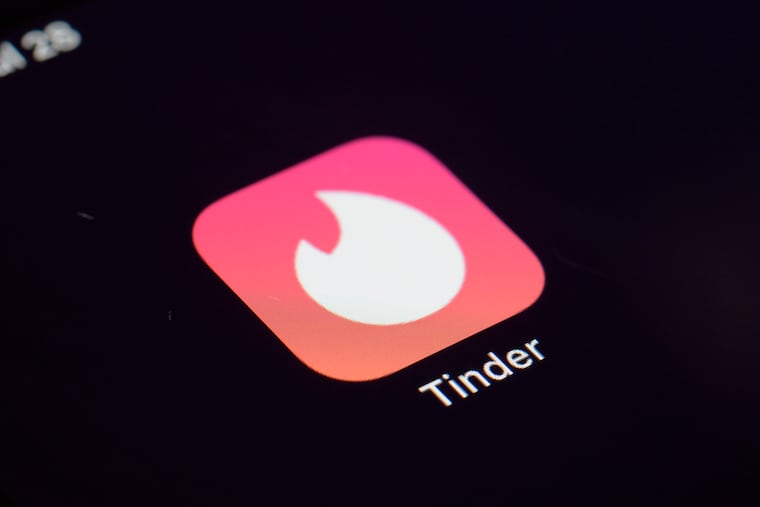 The icon for the dating app Tinder appears on a device in 2020. Tinder, Hinge, and other dating apps are designed with addictive features that encourage “compulsive” use, a proposed class action lawsuit against parent company Match Group claims.