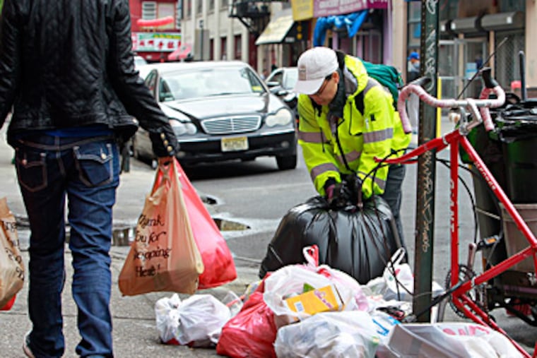 Susan Chung, member of the Chinatown cleanup crew, patrols the streets, collecting trash on the sidewalk. AKIRA SUWA / Staff Photographer