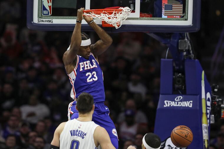 Jimmy Butler dunks in the third quarter against the Magic on Tuesday.