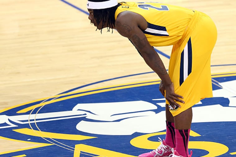 La Salle's Tyrone Garland bends over after a tough loss. (Yong Kim/Staff Photographer)