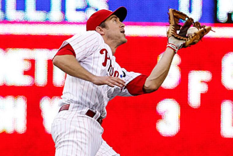 Chase Utley reaches back to catch a fly ball in the second inning. (Ron Cortes/Staff Photographer)
